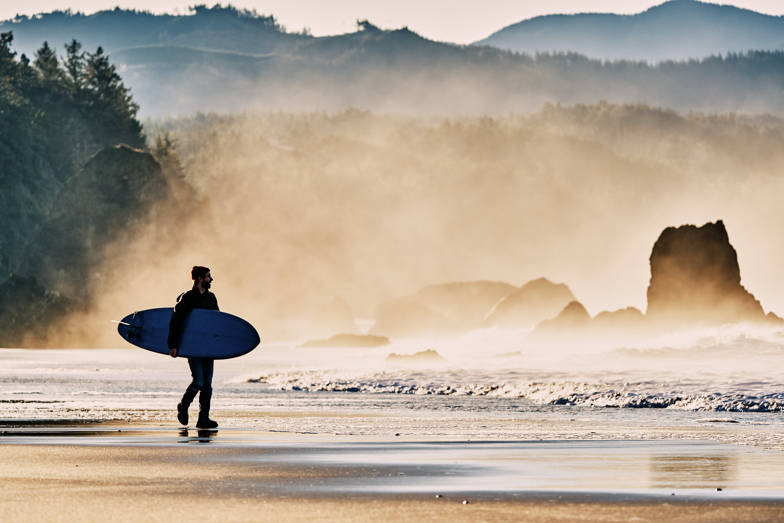 Surfer looking for waves on the Southern Oregon Coast wearing Danner Mountain Light