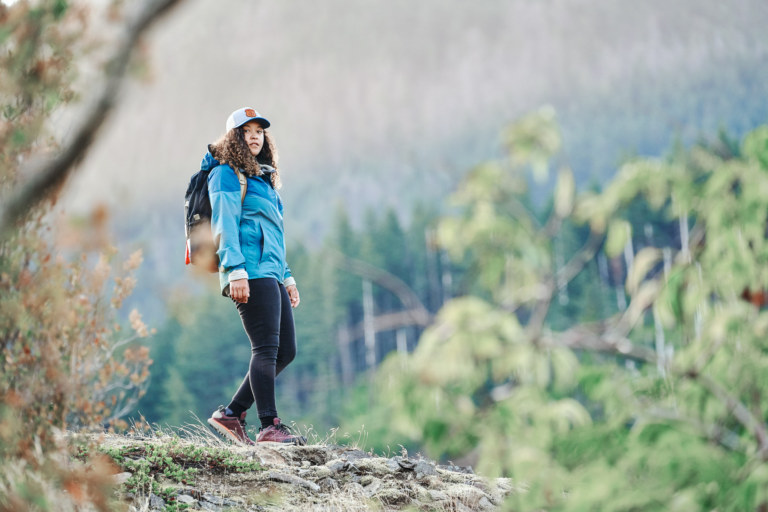 Women hiker enjoying the morning light on the Pacific Crest Trail wearing Danner 2650. 