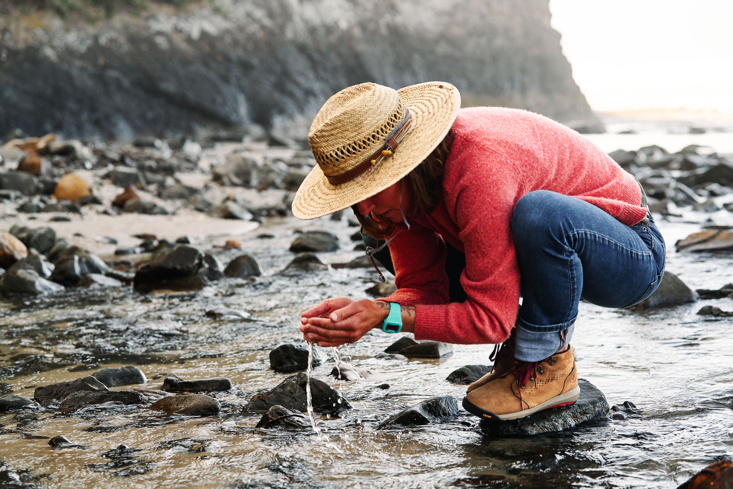 Lauren Ahlgren of Oregon Surf Adventures finding a cold drink of water while wearing Danner Inquire Boots on the Oregon Coast.