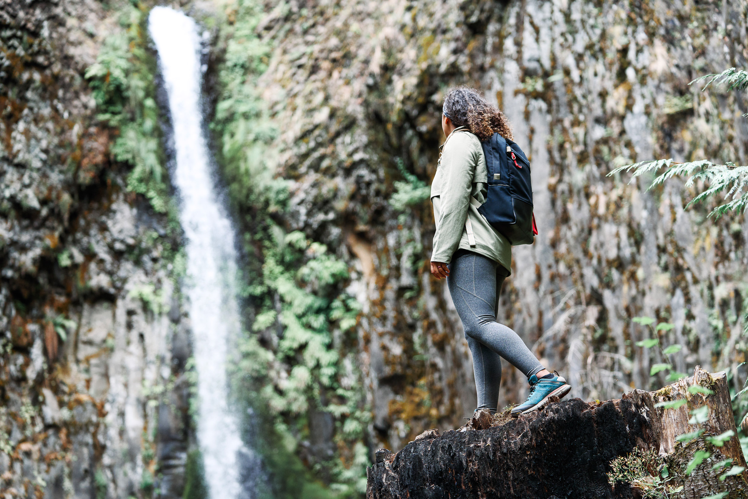 Women Hiking Pacific Crest Trail wearing Danner 2650 while looking at a water fall. 